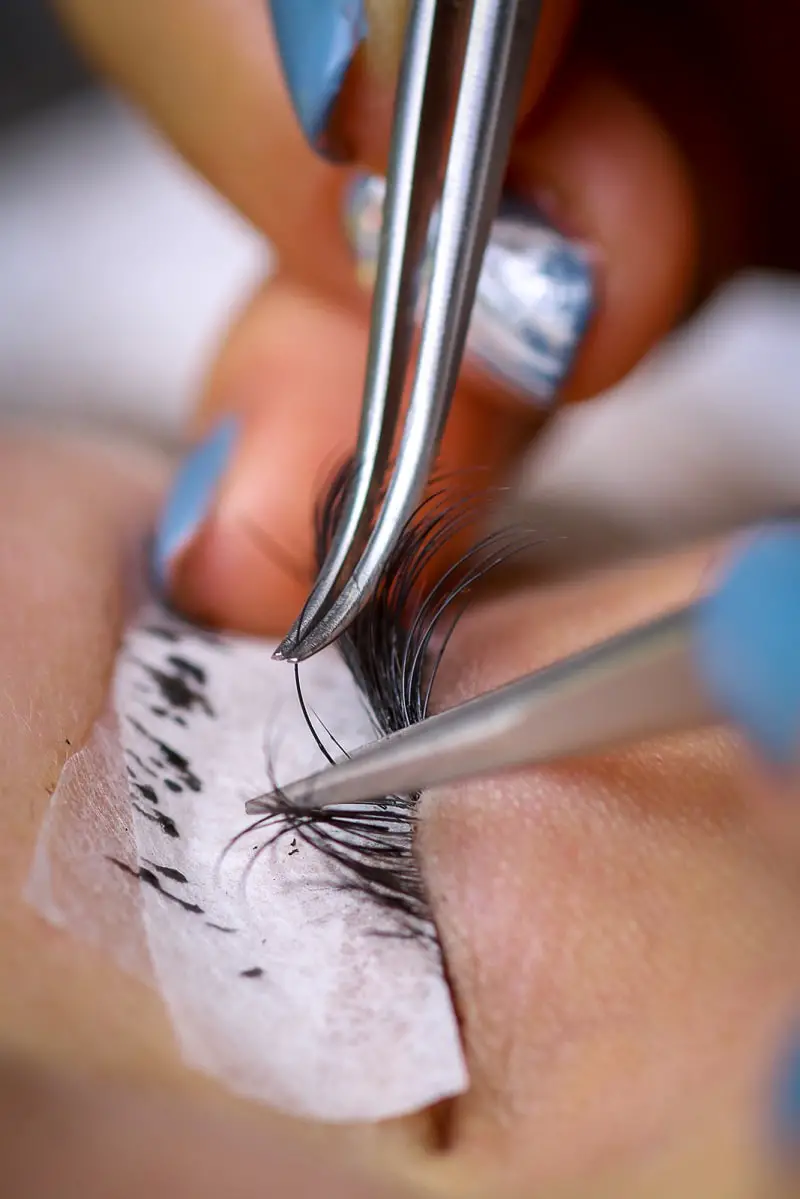close-up of woman's eye undergoing a lash extension procedure