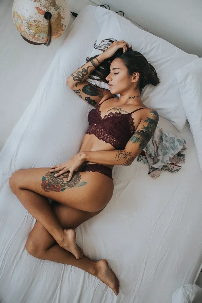 sexy young woman in a bikini sleeping on a bed