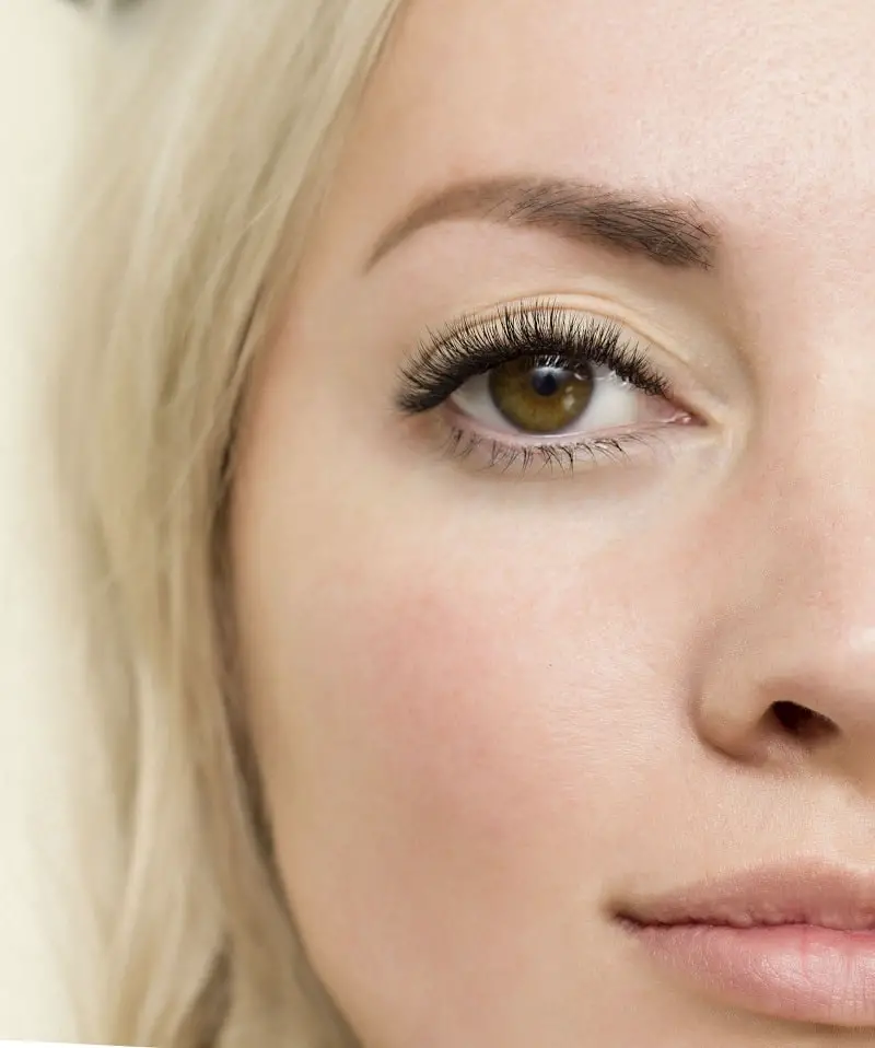 close-up shot of a woman's face with long eyelashes